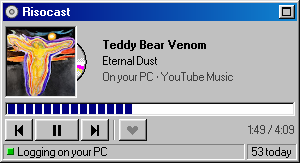 The Now playing widget showing a song playing on the PC: “On your PC · YouTube Music” under the title, and “Logging on your PC” in the status bar